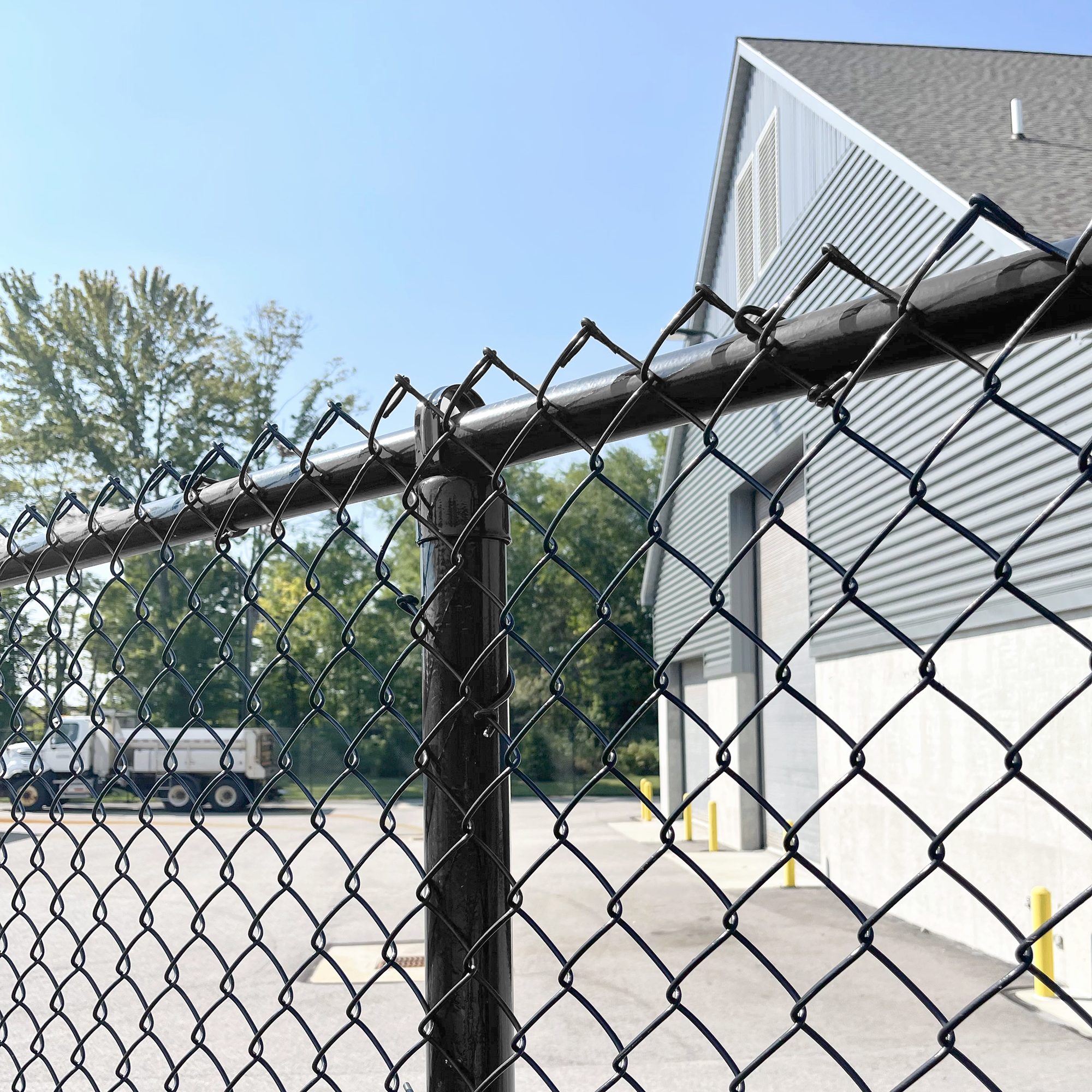 Black Chain Link Fence Up Close Installed With Black Mesh