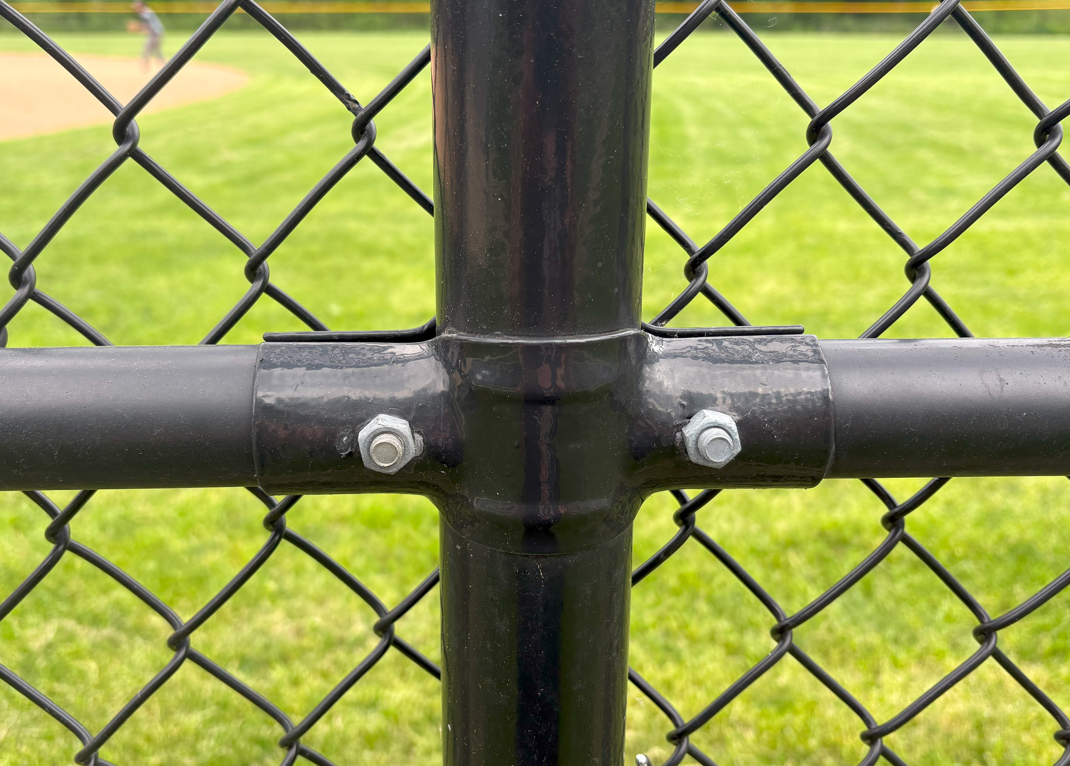 black chain link fence tension band installation up close