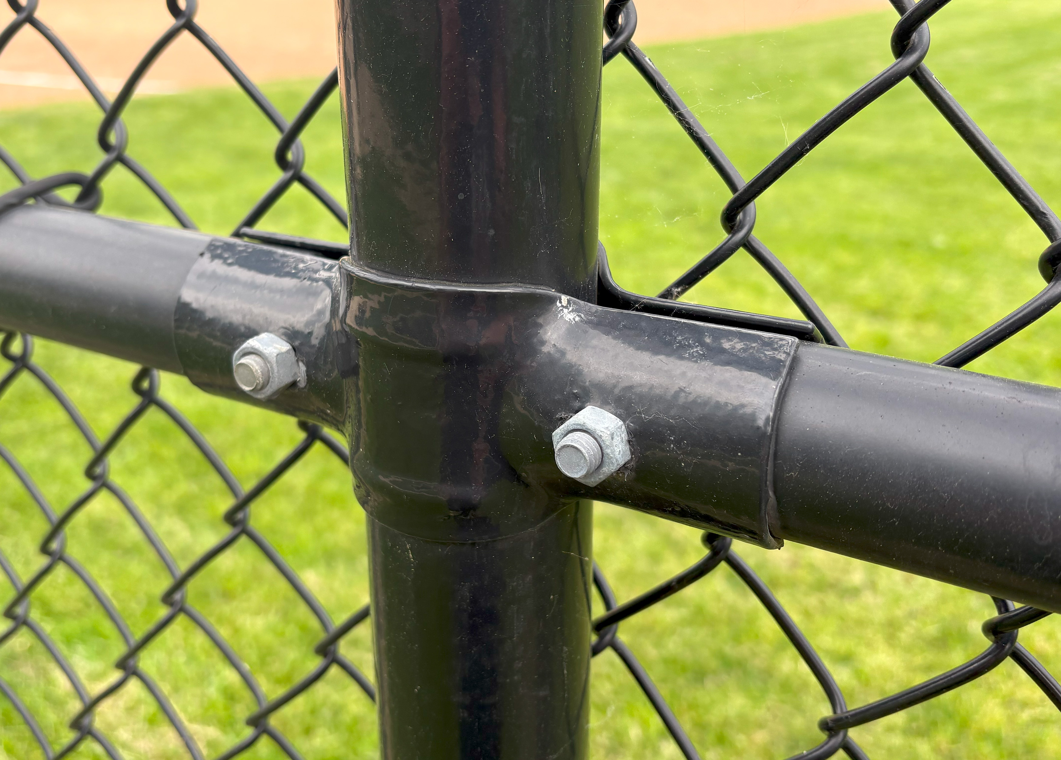 black chain link fence tension band installation up close